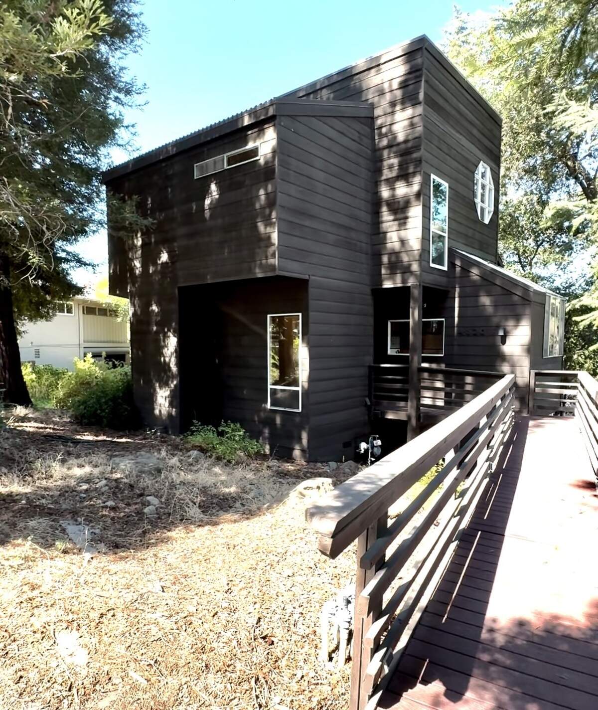 The front of a custom 1978 home at 4520 S. Land Park Drive in Sacramento shows its elevated, wood-forward architecture. The approximately 1,668-square-foot residence, designed by Sacramento architect Roger Scott, is for sale for the first time.
